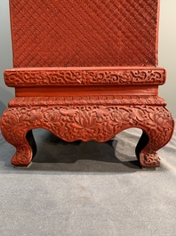 A Chinese cinnabar lacquer 'mountainous landscape' cabinet on a stand, 19th C.