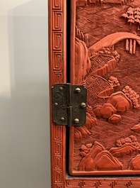 A Chinese cinnabar lacquer 'mountainous landscape' cabinet on a stand, 19th C.