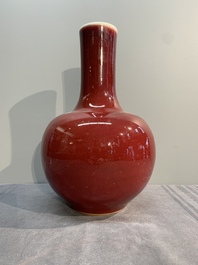 A Chinese apple-green-glazed and two copper-red-glazed bottle vases, Kangxi mark, 19/20th C.