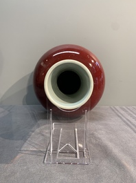 A Chinese apple-green-glazed and two copper-red-glazed bottle vases, Kangxi mark, 19/20th C.