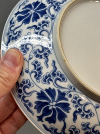 A pair of imperial Chinese blue and white 'lotus scroll' plates, Qianlong mark and of the period