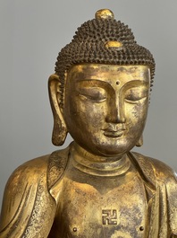An impressive and large Chinese gilt bronze Buddha, Ming, 16th C.
