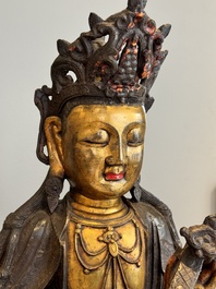 An impressive and large Chinese partially lacquered and gilt bronze Guanyin on a lotus throne, Ming