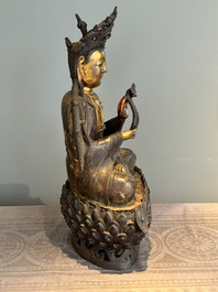 An impressive and large Chinese partially lacquered and gilt bronze Guanyin on a lotus throne, Ming