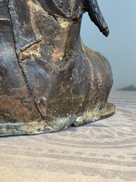 An impressive and large Chinese partially lacquered and gilt bronze Guanyin on a lotus throne, Ming