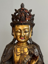 An impressive and large Chinese partially lacquered and gilt bronze Guanyin on a lotus throne, Ming
