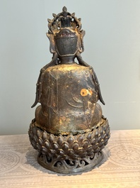 An impressive and large Chinese partially lacquered and gilt bronze Guanyin on a lotus throne, Ming