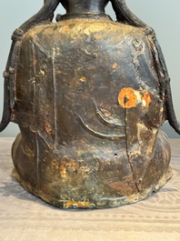 An impressive and large Chinese partially lacquered and gilt bronze Guanyin on a lotus throne, Ming