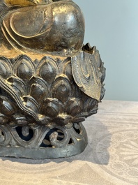 An impressive and large Chinese partially lacquered and gilt bronze Guanyin on a lotus throne, Ming
