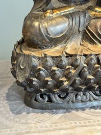 An impressive and large Chinese partially lacquered and gilt bronze Guanyin on a lotus throne, Ming