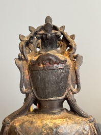 An impressive and large Chinese partially lacquered and gilt bronze Guanyin on a lotus throne, Ming