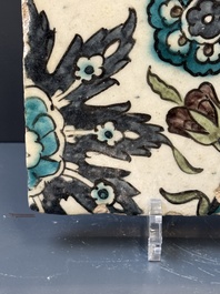 A Syrian Damascus Iznik-style tile with grape and flower scrolls, early 17th C.