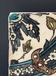A Syrian Damascus Iznik-style tile with grape and flower scrolls, early 17th C.