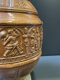 A Raeren stoneware 'peasant dance' jug, late 16th C.