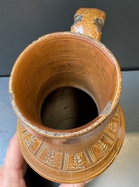 A Raeren stoneware 'peasant dance' jug, late 16th C.