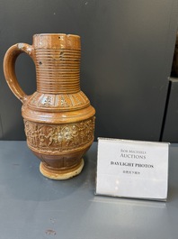A Raeren stoneware 'peasant dance' jug, late 16th C.