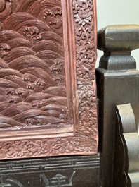 A rectangular Chinese carved red lacquer 'dragon' table screen, later wooden stand, Qianlong
