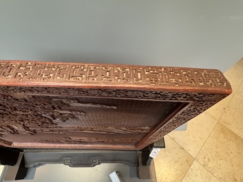 A rectangular Chinese carved red lacquer 'dragon' table screen, later wooden stand, Qianlong
