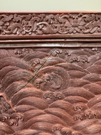 A rectangular Chinese carved red lacquer 'dragon' table screen, later wooden stand, Qianlong