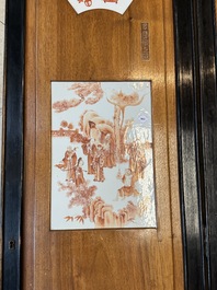 A Chinese four-part folding screen with iron-red-decorated porcelain plaques, 19/20th C.