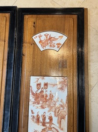 A Chinese four-part folding screen with iron-red-decorated porcelain plaques, 19/20th C.
