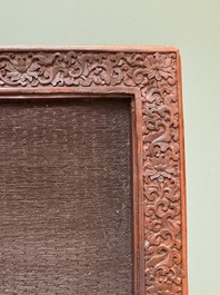 A rectangular Chinese carved red lacquer 'dragon' table screen, later wooden stand, Qianlong
