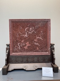 A rectangular Chinese carved red lacquer 'dragon' table screen, later wooden stand, Qianlong