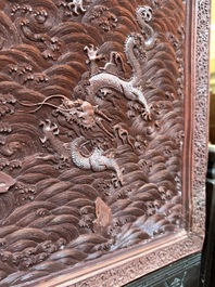 A rectangular Chinese carved red lacquer 'dragon' table screen, later wooden stand, Qianlong