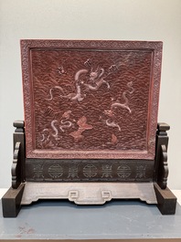A rectangular Chinese carved red lacquer 'dragon' table screen, later wooden stand, Qianlong