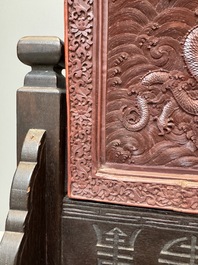 A rectangular Chinese carved red lacquer 'dragon' table screen, later wooden stand, Qianlong
