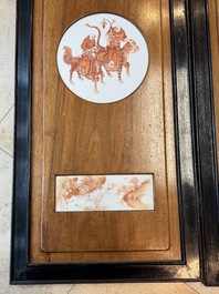 A Chinese four-part folding screen with iron-red-decorated porcelain plaques, 19/20th C.