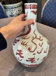 A Chinese copper-red and white 'dragon' bottle vase, 18th C.