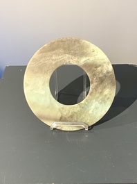A Chinese celadon and russet jade 'bi' disc, Neolithic period