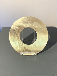 A Chinese celadon and russet jade 'bi' disc, Neolithic period