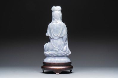 An exceptional and large Chinese carved pale lavender jadeite Guanyin on a wooden stand, Republic