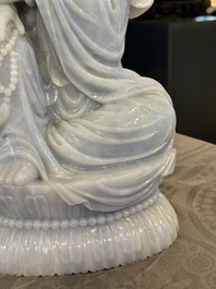 An exceptional and large Chinese carved pale lavender jadeite Guanyin on a wooden stand, Republic