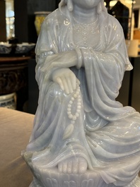 An exceptional and large Chinese carved pale lavender jadeite Guanyin on a wooden stand, Republic