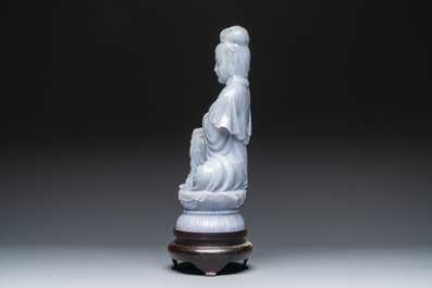 An exceptional and large Chinese carved pale lavender jadeite Guanyin on a wooden stand, Republic