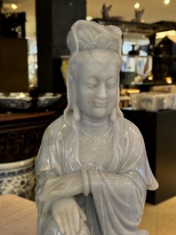 An exceptional and large Chinese carved pale lavender jadeite Guanyin on a wooden stand, Republic
