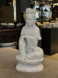 An exceptional and large Chinese carved pale lavender jadeite Guanyin on a wooden stand, Republic