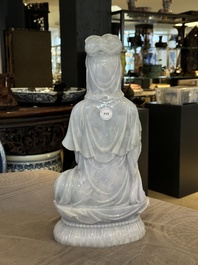 An exceptional and large Chinese carved pale lavender jadeite Guanyin on a wooden stand, Republic