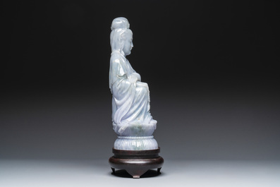 An exceptional and large Chinese carved pale lavender jadeite Guanyin on a wooden stand, Republic