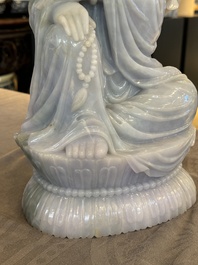 An exceptional and large Chinese carved pale lavender jadeite Guanyin on a wooden stand, Republic