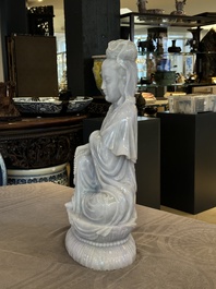 An exceptional and large Chinese carved pale lavender jadeite Guanyin on a wooden stand, Republic