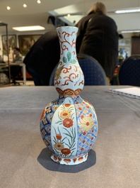 Two polychrome Dutch Delft petit feu vases with floral design, early 18th C.