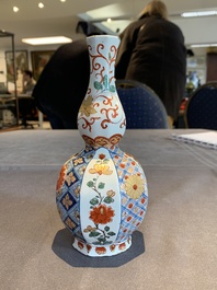 Two polychrome Dutch Delft petit feu vases with floral design, early 18th C.
