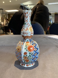 Two polychrome Dutch Delft petit feu vases with floral design, early 18th C.