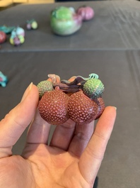 A collection of 12 Chinese famille rose fruit models, including a peach-shaped box and cover, 19th C.