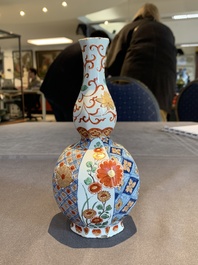 Two polychrome Dutch Delft petit feu vases with floral design, early 18th C.