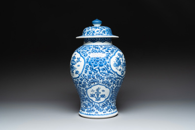 A Chinese blue and white 'antiquities and peony scrolls' vase and cover, Kangxi